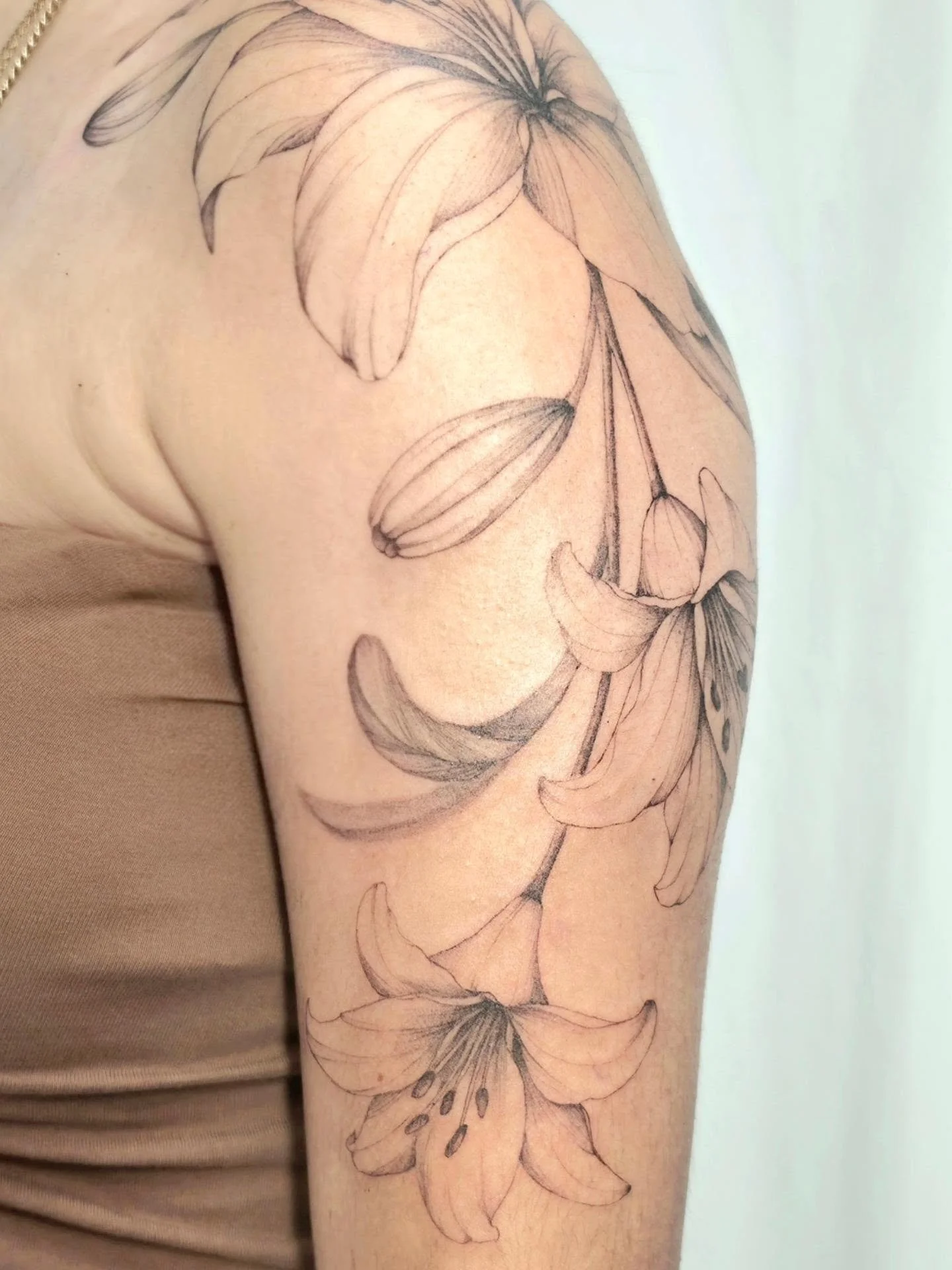 Lilies flowing with the shape of the arm 🤍 Loved creating this larger fine line floral piece with soft shading and an airy, natural flow.

Fill out the Form in my bio to book!
Booking for: OCTOBER - DECEMBER 
Don't forget to tag me in your pictures 
