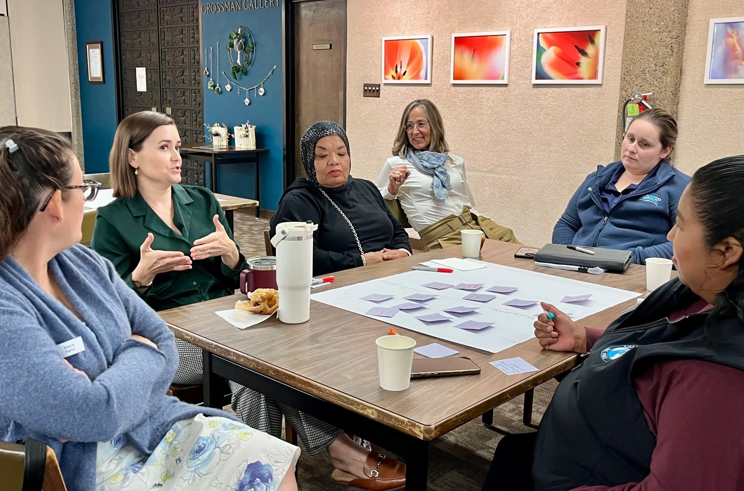 Team members gather for an initial planning session on Housing and Economic Security