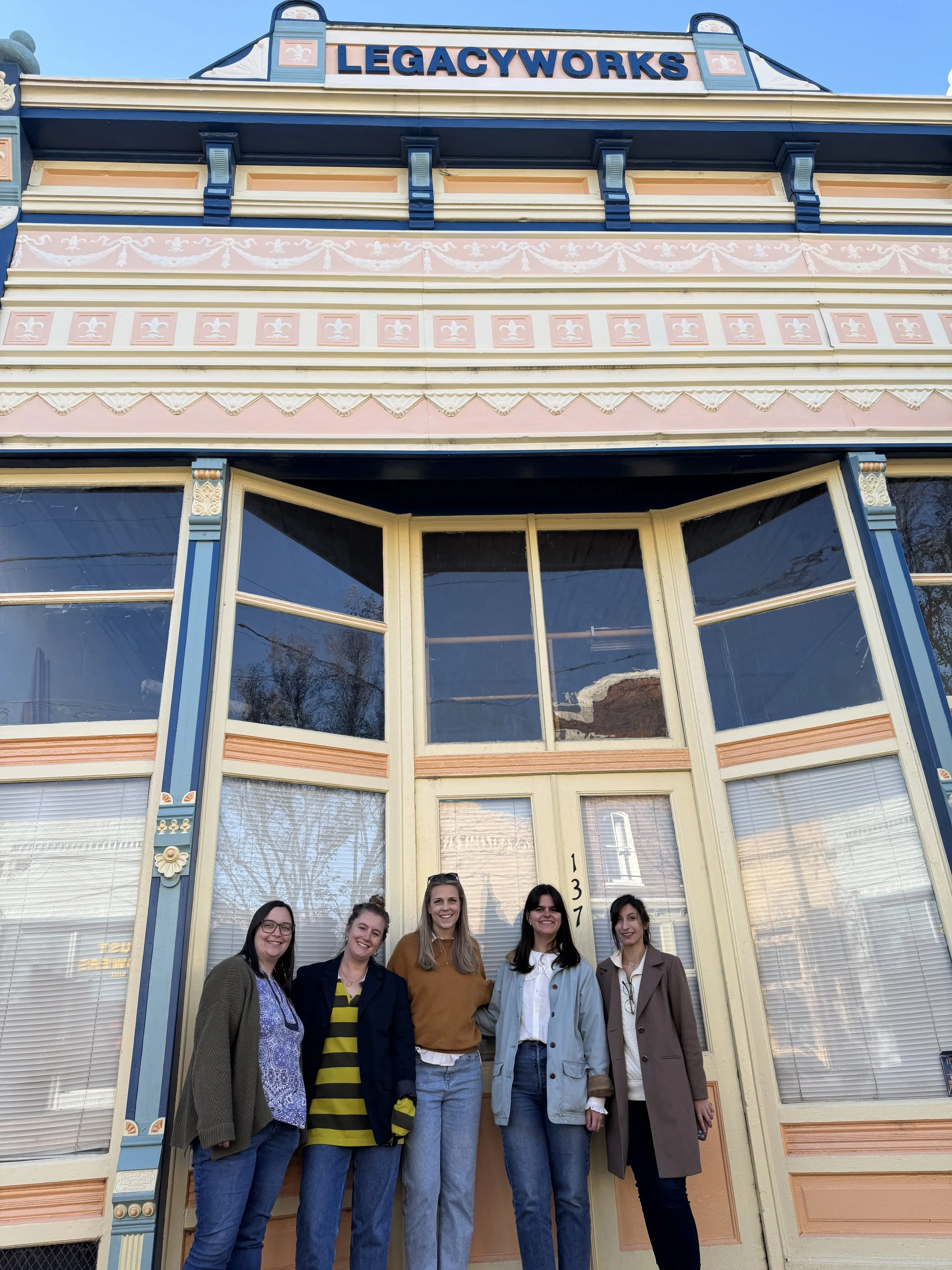 Salem Carriker, Jordan Rich, Ellen Snow, Marguerite Leek and Olivia Percoco stand in front of colorful building in Warrenton, NC.