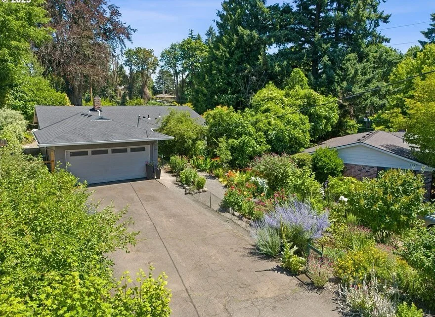 Tucked away on the end of a hidden dead-end street. The location is breathtaking! The oversized backyard looks out onto green space and is cultivated to perfection. Sitting high above the Springwater Corridor, which is not accessible from property, t