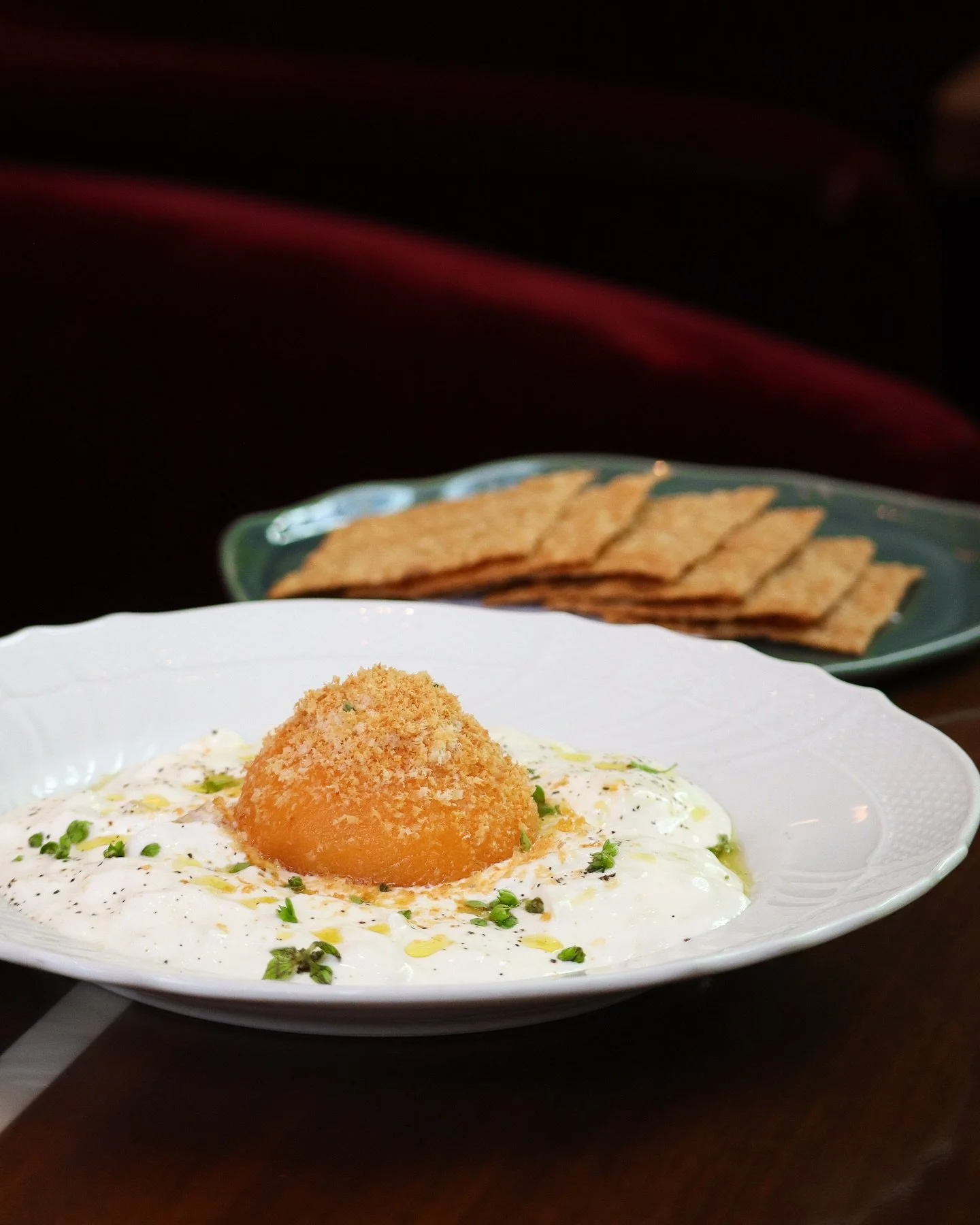 Stracciatella // peaches, hazelnuts, and basil
&nbsp;
A study in balance, texture, and late-summer sweetness, this dish layers smoky peach butter and champagne-poached fruit over rich cheese, served with crisp olive oil crackers.
&nbsp;
Its sunny-sid