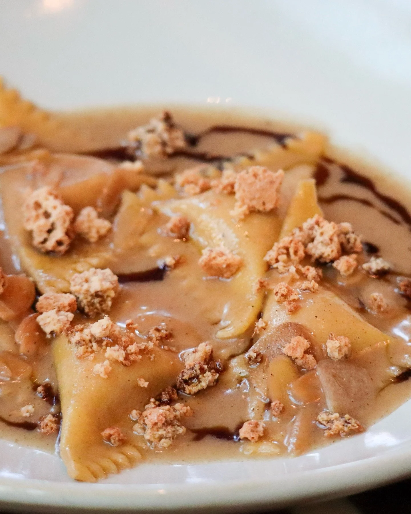 A nod to Friuli&rsquo;s storied pastas, our Triangoli di Zucca layers sweet and savory in exquisite harmony &mdash; hand-folded pasta filled with spiced pumpkin and apple mostarda, tossed in brown butter with toasted almonds and garnished with a whis