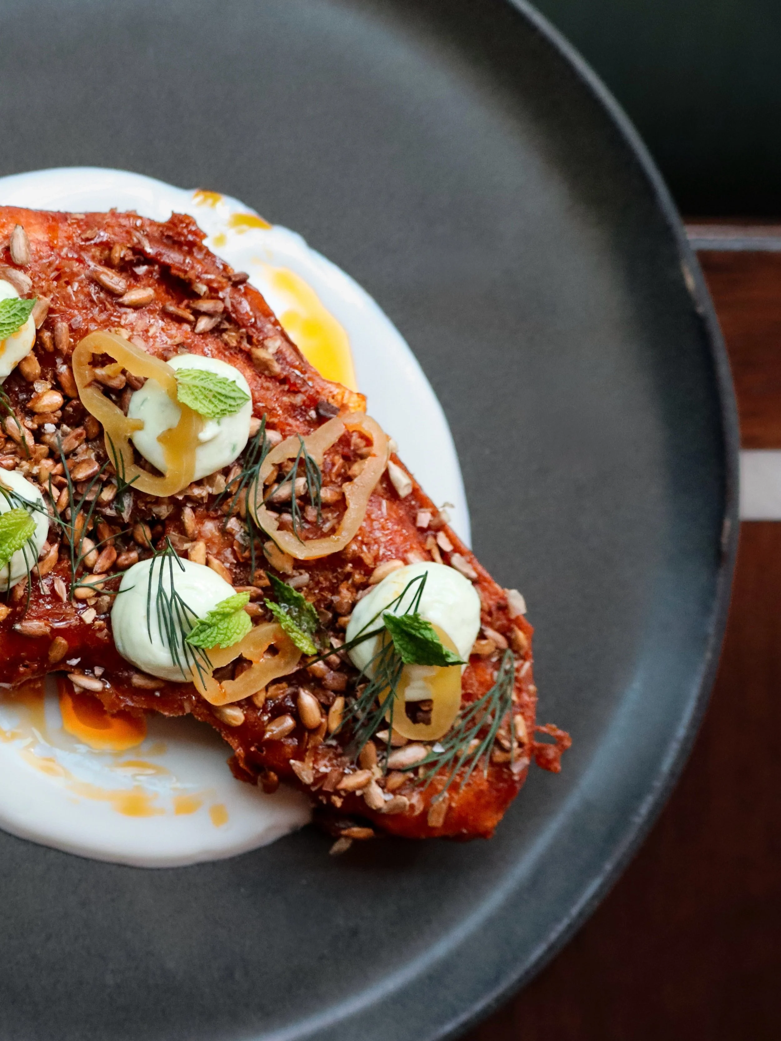 The yogurt accompanying Melanzane Ripiene begins with cream infused over embers from the previous night&rsquo;s coals, imparting a delicate, lingering smokiness.

Served cool alongside cast-iron roasted eggplant layered with herb ricotta, it offers a