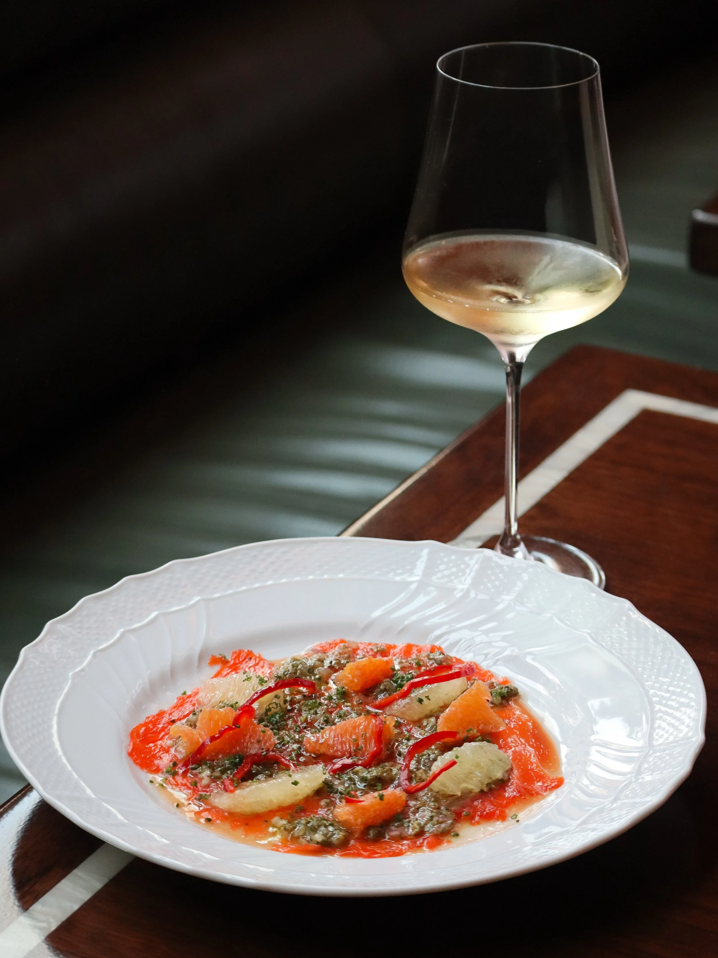Silken steelhead trout is dressed with citrus conserva and a caper and quince vinaigrette, vivid with acidity against the richness of the fish. Almonds crackle between the tender slices, followed by the lush, fruity roundness of olive oil.

Bright, b