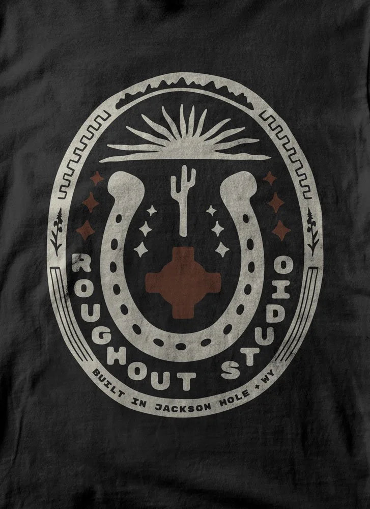 Roughout Studio, Logo with horseshoe, cactus, sunburst, and stars; text reads "Roughhouse Outpost" and "Built in Jackson Hole, WY".