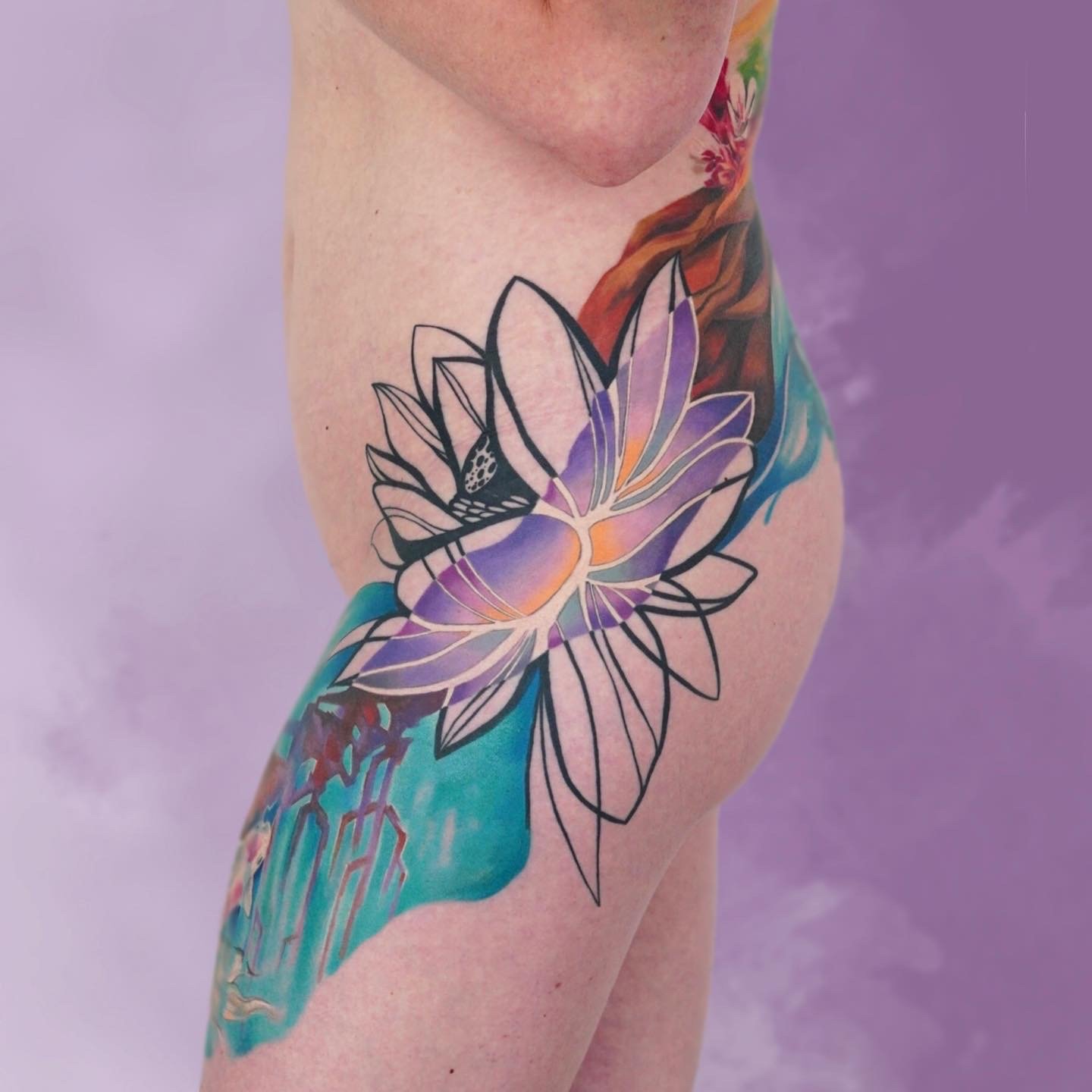 Tattoo of a purple and orange butterfly surrounded by a black outline, with colorful abstract background on person's upper arm and shoulder.