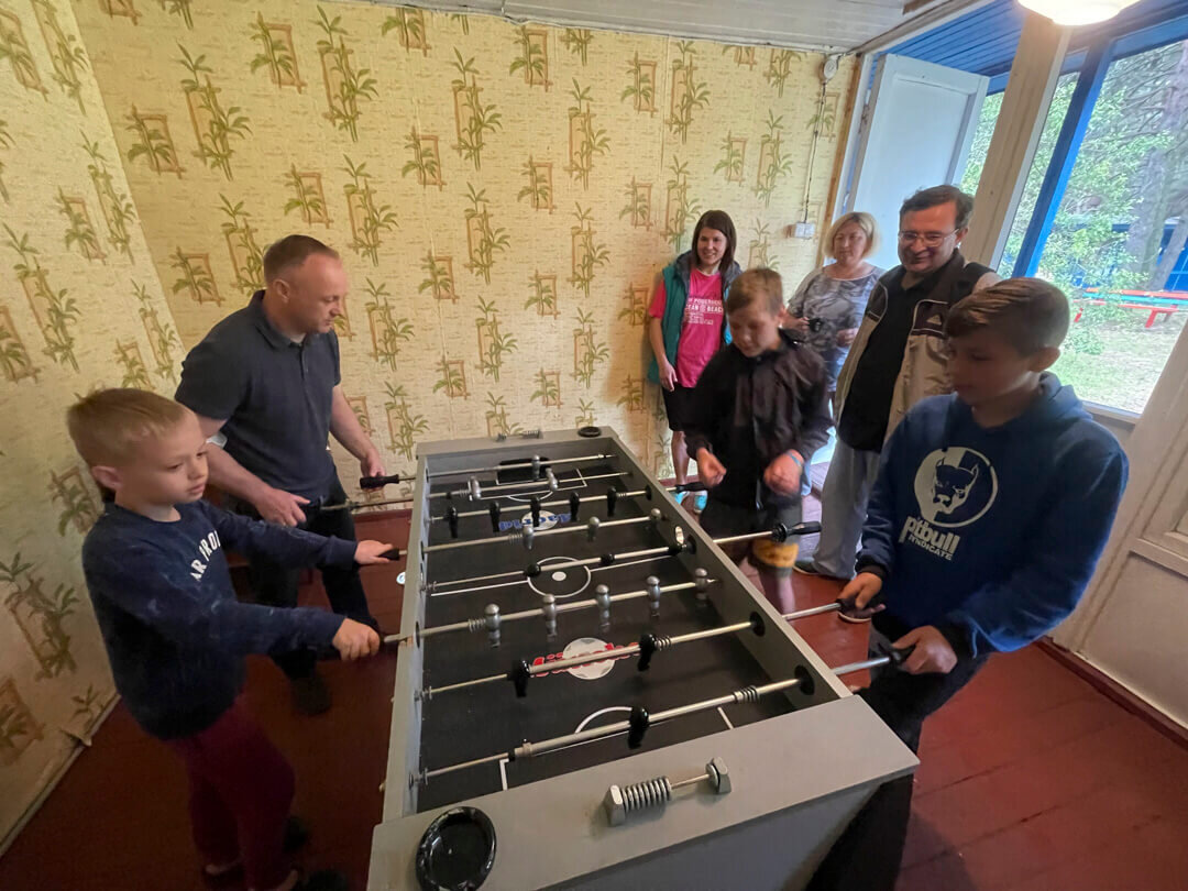 Pastor Ruslan plays _table soccer_ with campers_resized_1080 width.jpeg