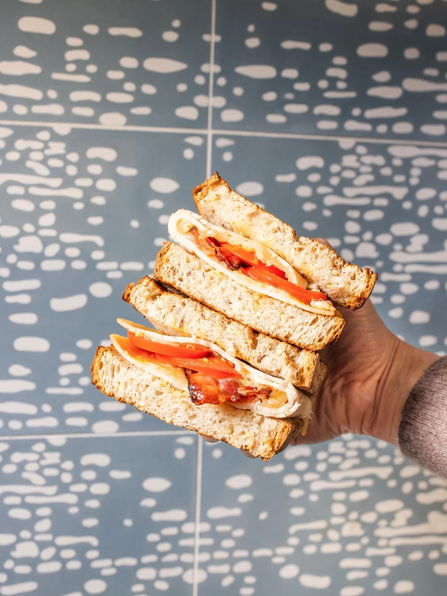 Club sandwich, halved... but too good to share.

Turkey, Muenster, bacon, tomato, and honey mustard on your bread / bagel of choice.