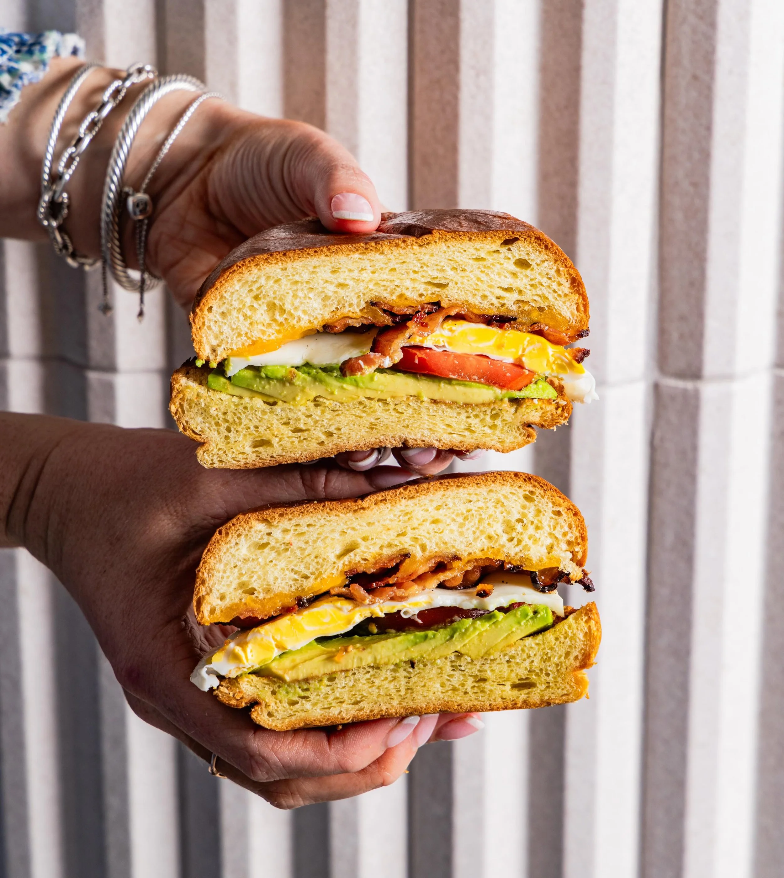 A true fan favorite: Hometown Breakfast Sandwich

Loaded with egg, bacon, cheddar, tomato, and avocado on brioche.