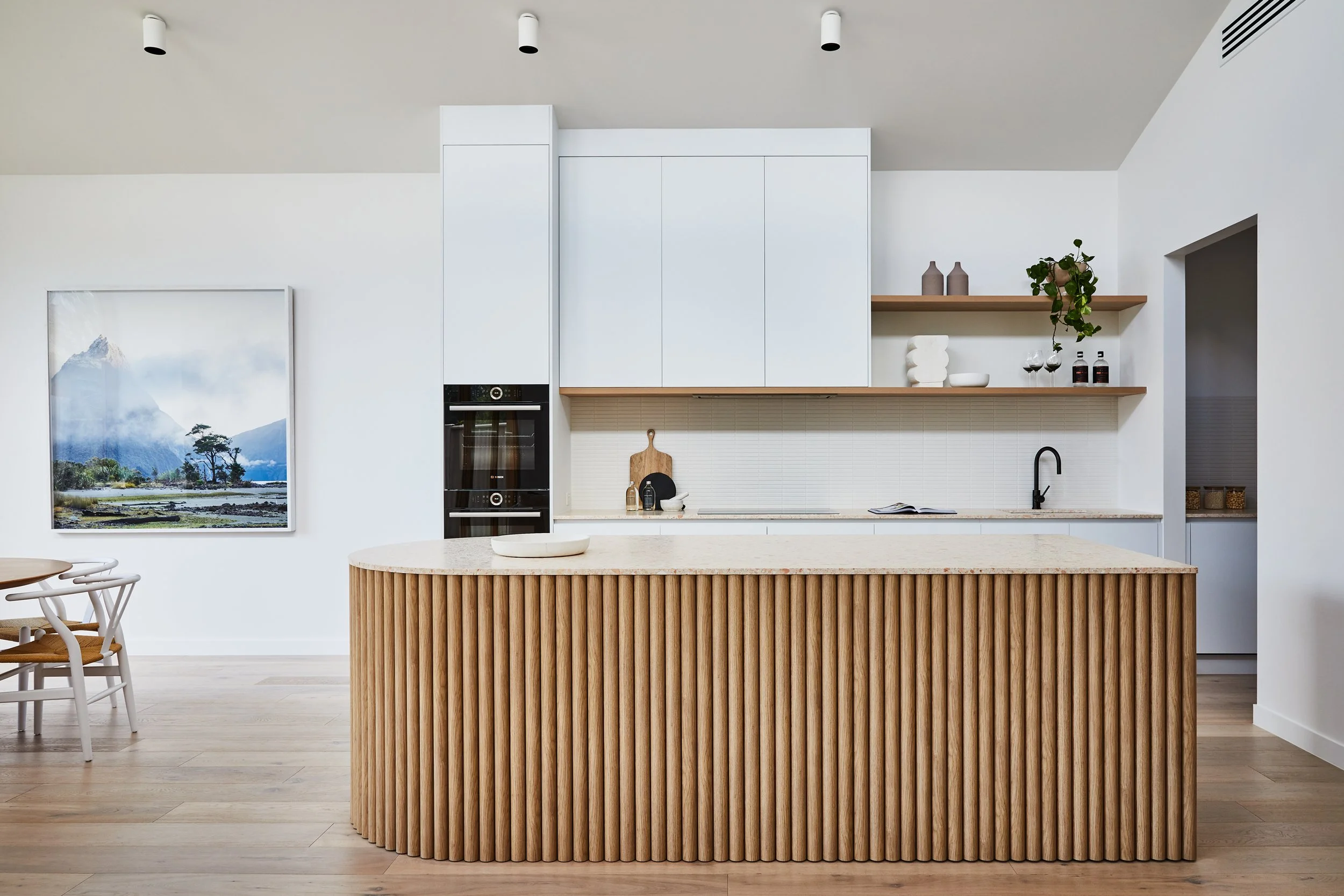 Curved kitchen in a high performance home in Sunshine built by Carland Constructions