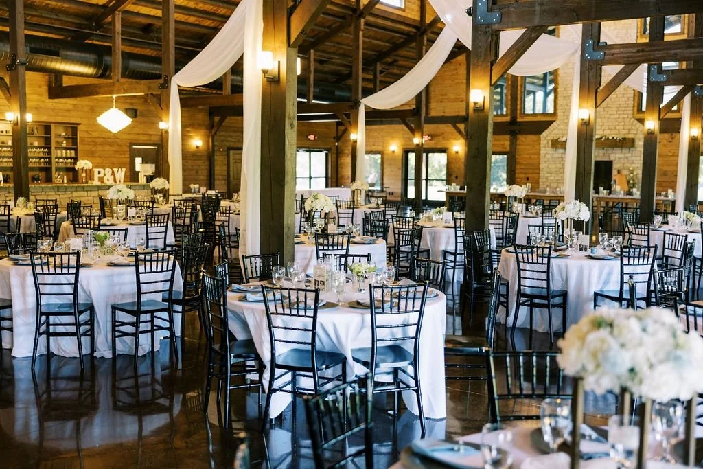 Elegant indoor wedding reception with luxury linens, draping, table decor and lighting at a wedding venue near Cincinnati