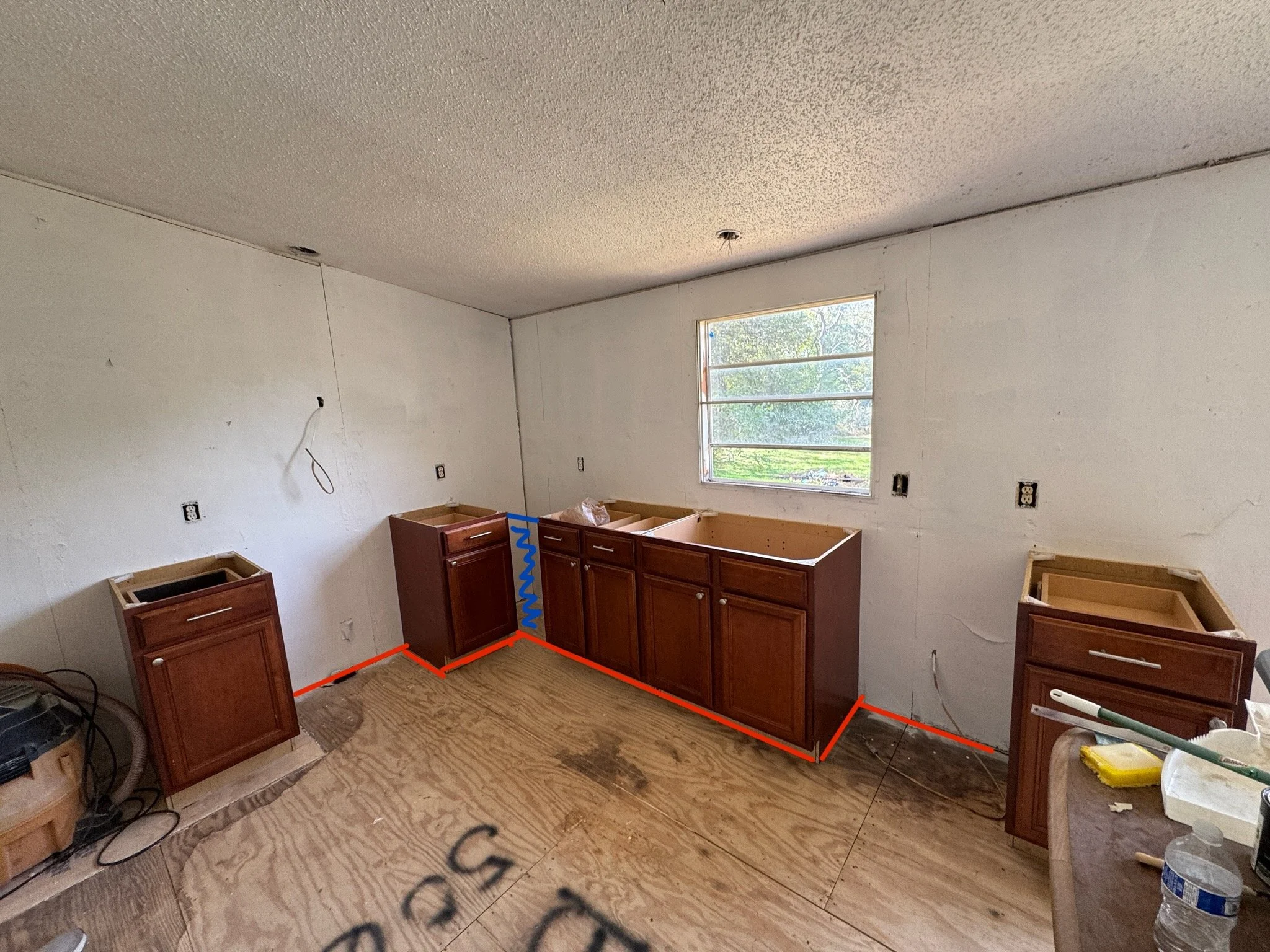 Thanksgiving Story &mdash; Thankful for Cabinets!
The original cabinets were rough &mdash; broken doors, rusty hinges, and countertops literally taped together. We were determined to scrub, clean, and paint them just to make things look better.
But M