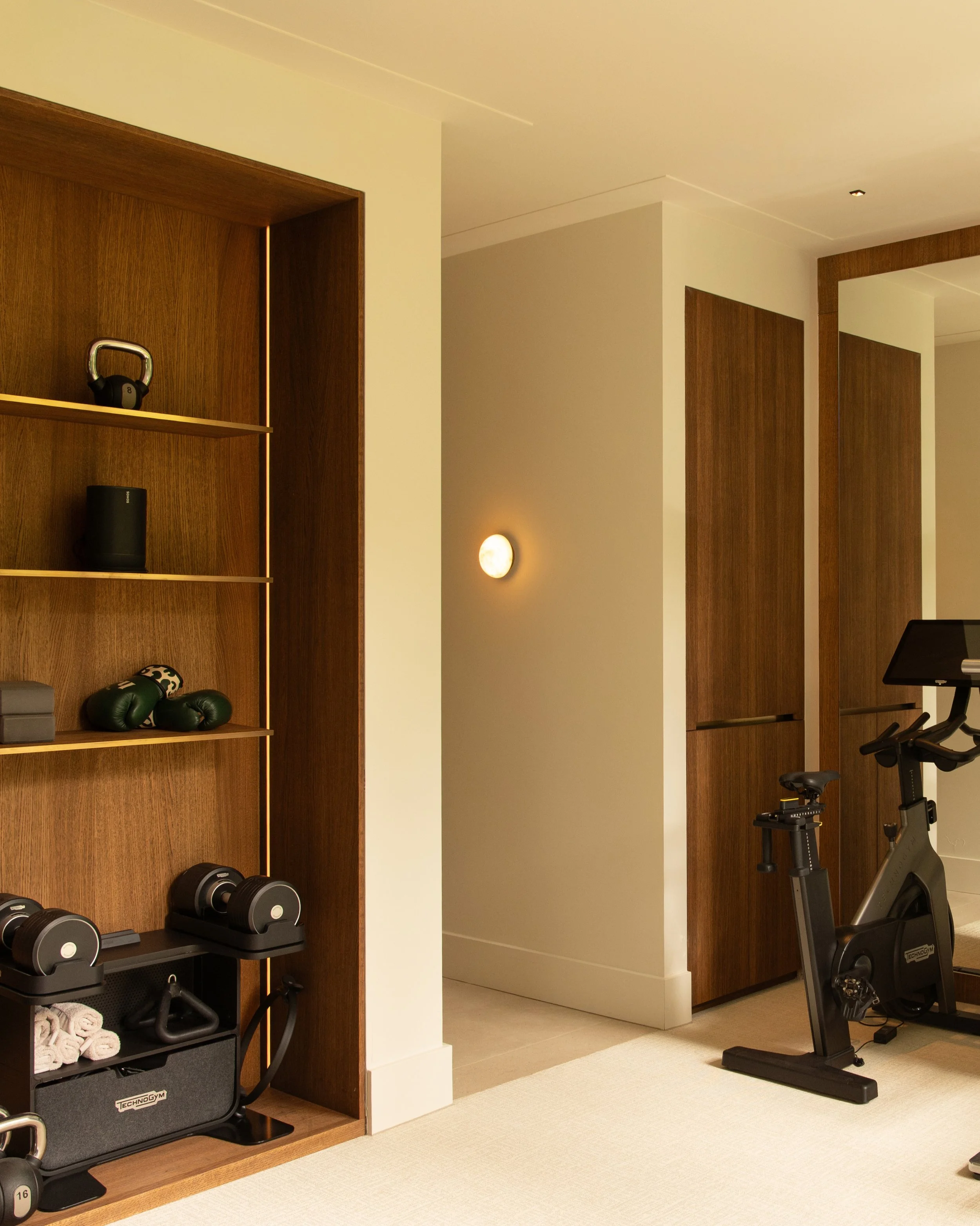 Project RV - Designed as a private retreat, this wellness space combines a gym, sauna and cold plunge with custom walnut joinery and a soft, neutral palette. A calm environment dedicated to recovery, relaxation and wellbeing.