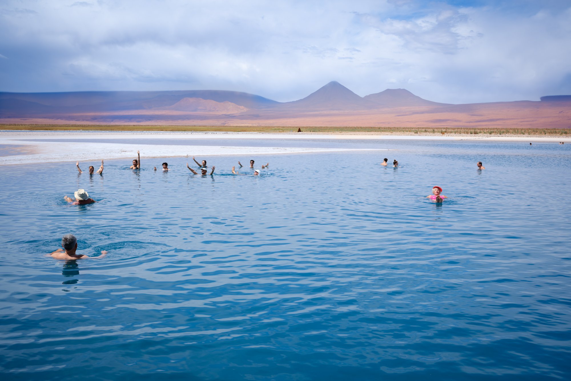 Atacama desert, Chile. Salt lagoon. The people are floating atop the water.