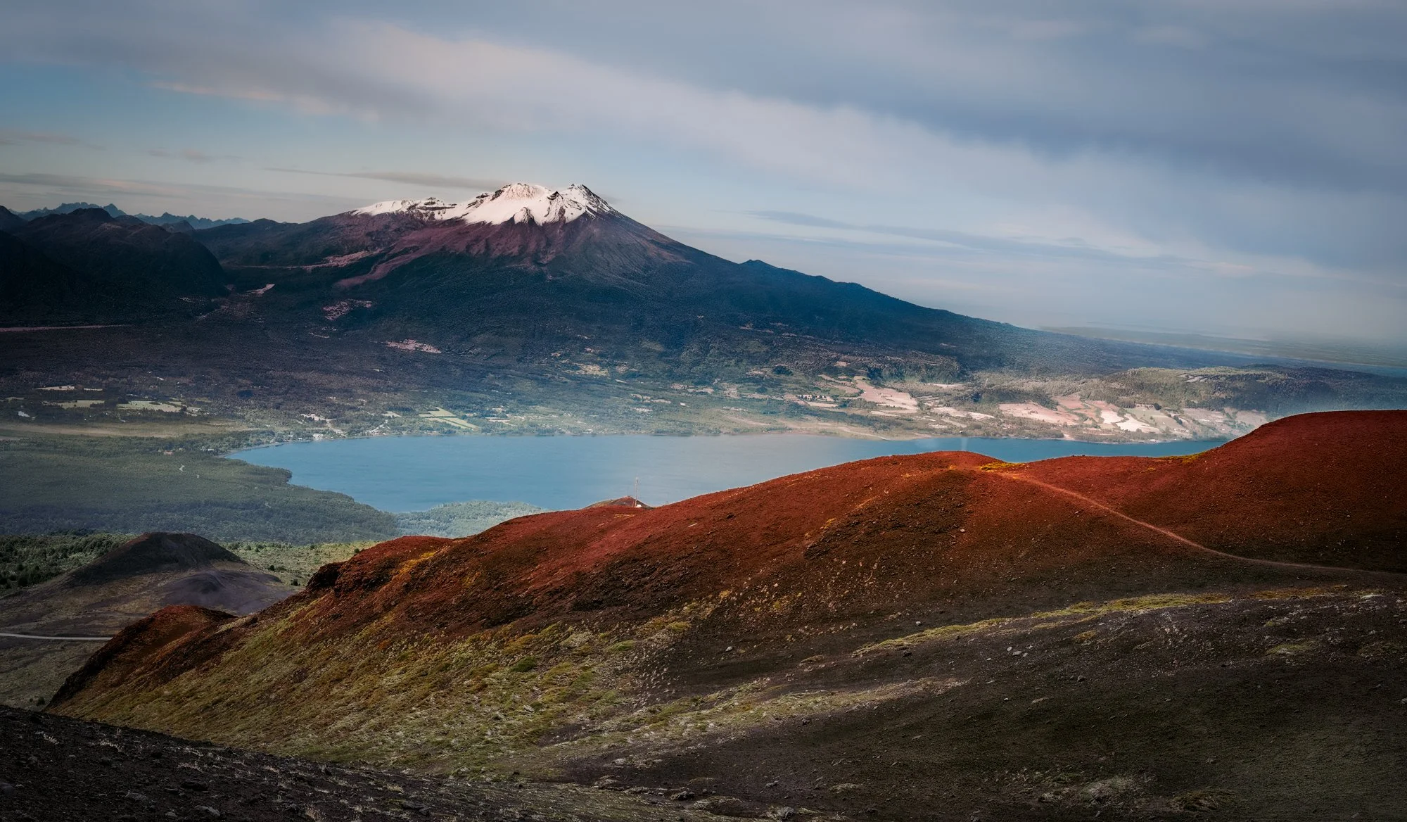 Along my hiking trail on Osorno Volcano, near Puerto Varas, Chile. I am looking down at Lake Llanquihue and the Calbuco Volcano.