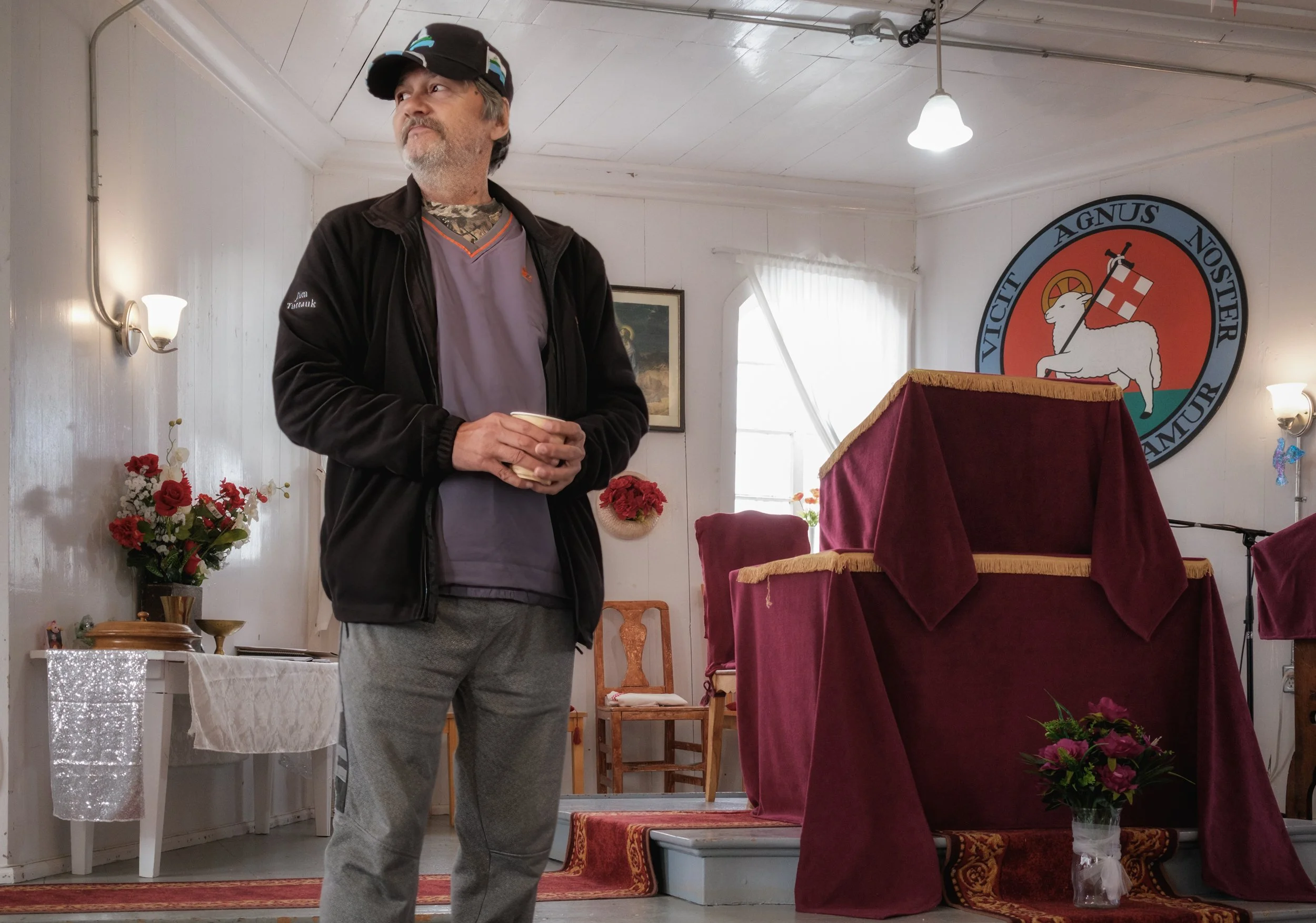 Mayor of Hopedale, standing within the Hopedale Missionary Church. The church is a National Historic Site of Canada. Missionaries came in 1782 to convert the population.