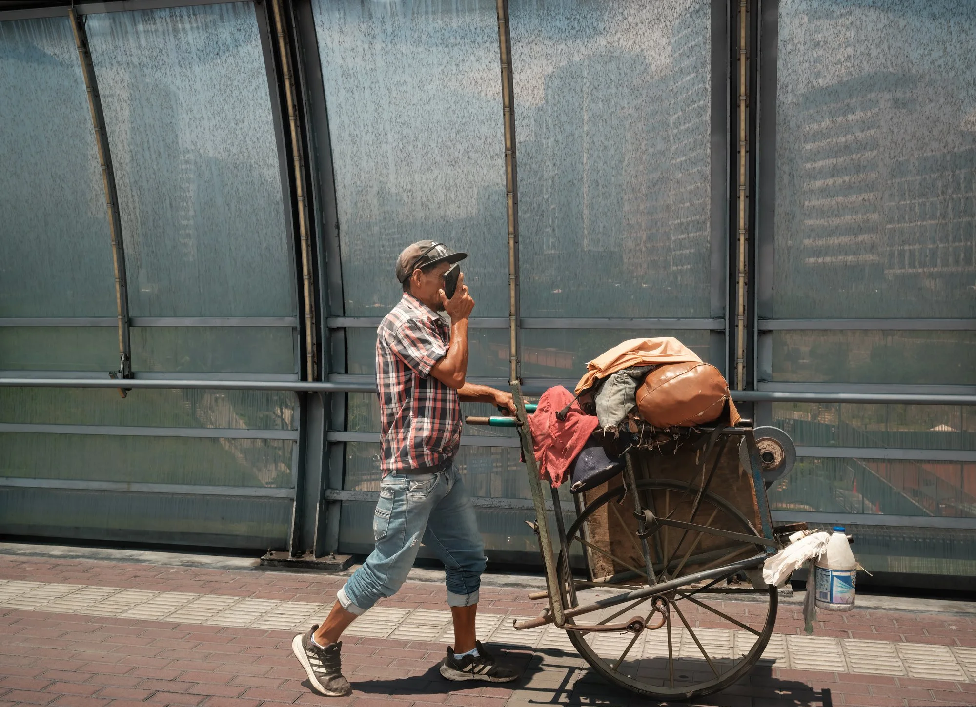 Lima, Peru.  An apparent homeless guy dressed nicely by U.S. standards, and using a cell phone!!  