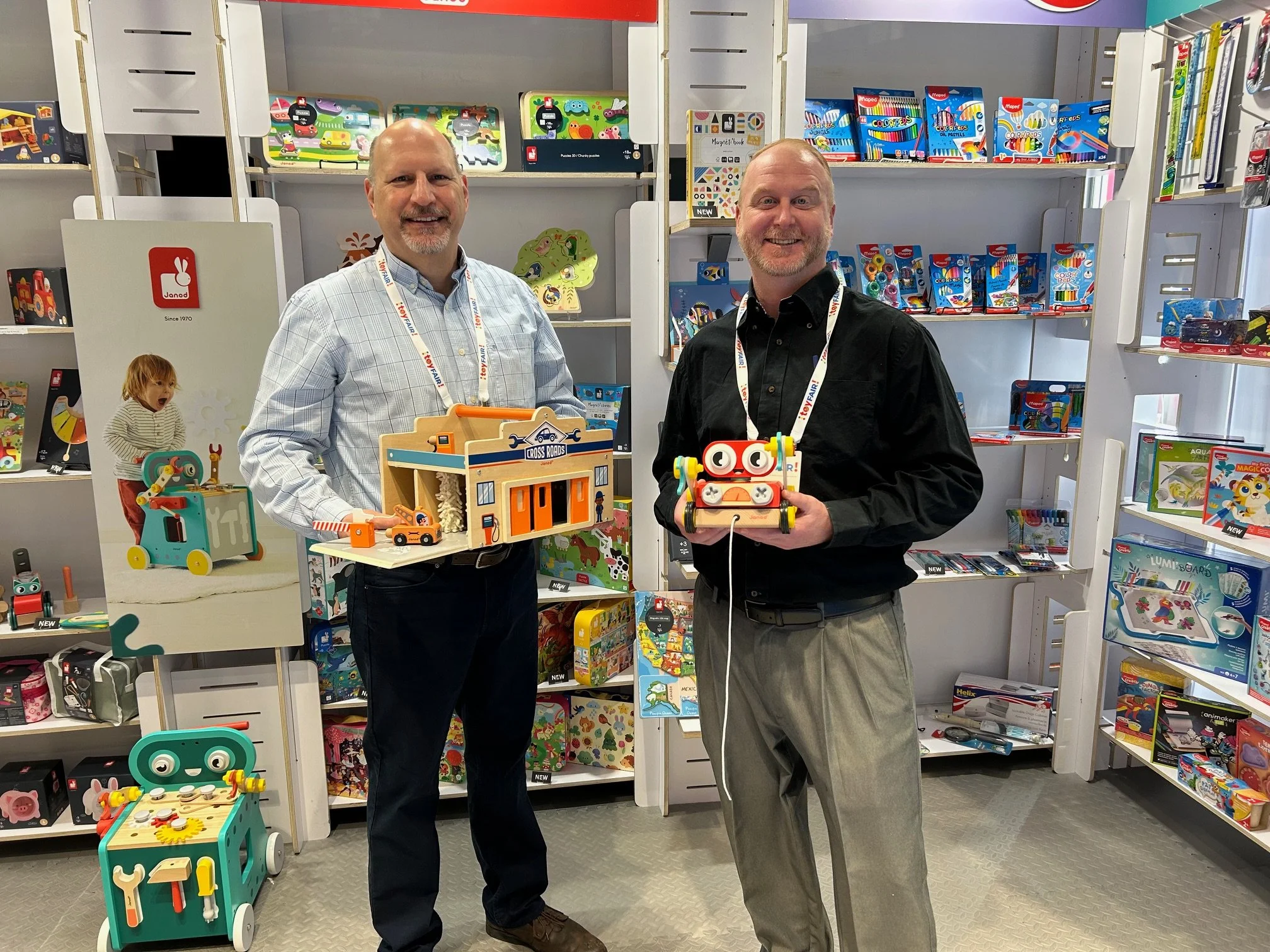 Matt from Maped-Juratoys showing the Brico'kids DIY Robot while Mike is holding Stu's favorite "Crossroads My First Garage"