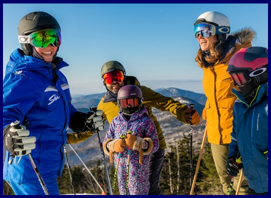 Stowe instructors with a young skier