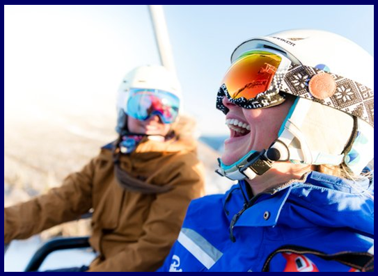 Stowe instructor riding a lift with guests
