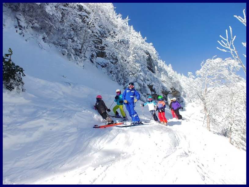 Stowe instructors skiing on snowy terrain