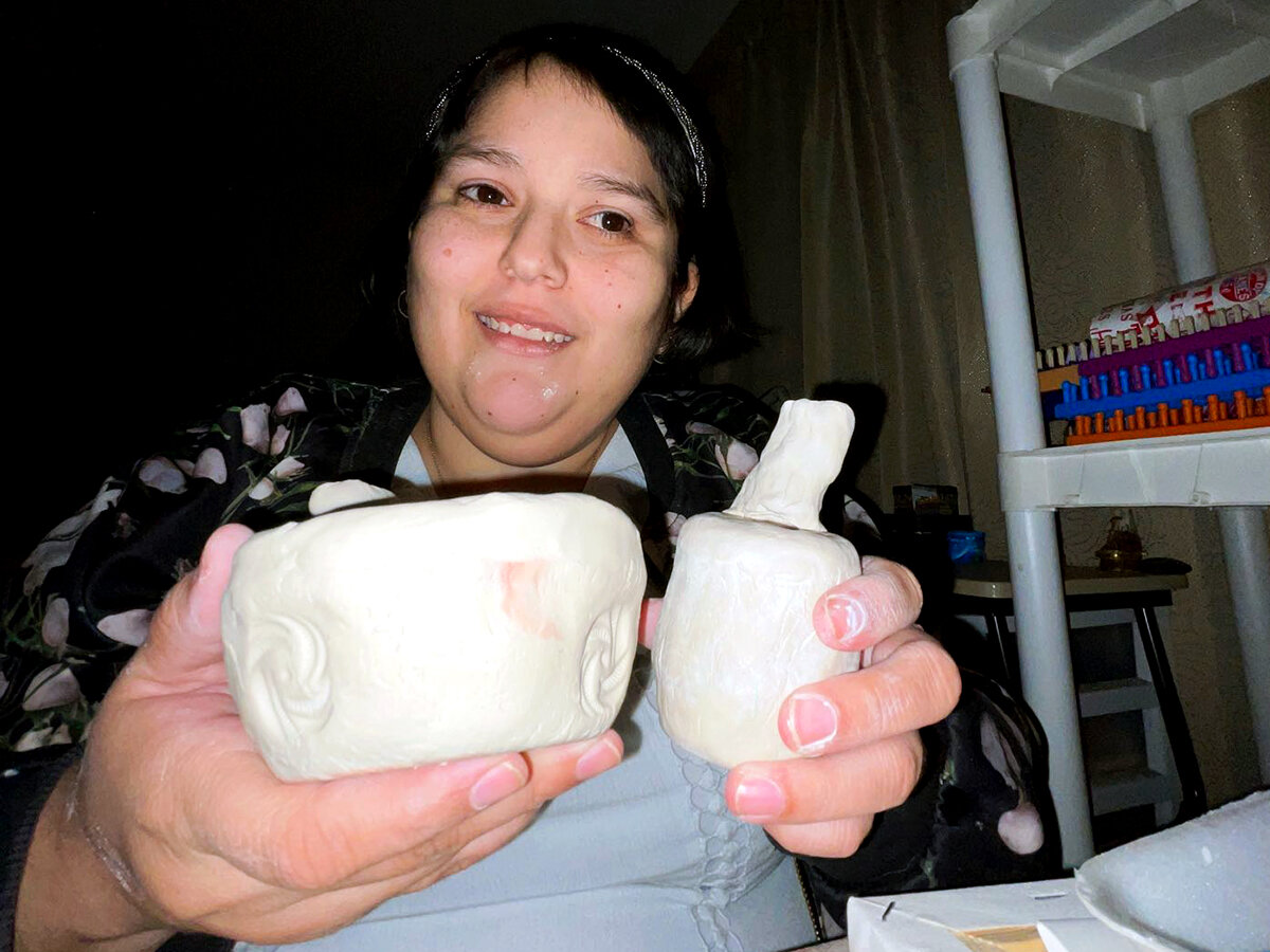Valerie holding two of her pinch pots