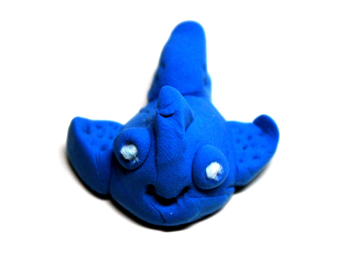 Small blue clay fish with carved fin designs (front)