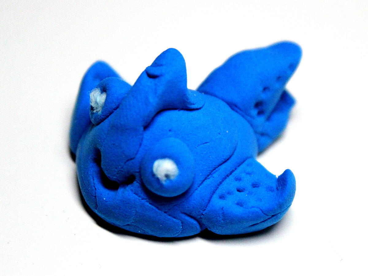 Small blue clay fish with carved fin designs (3/4)