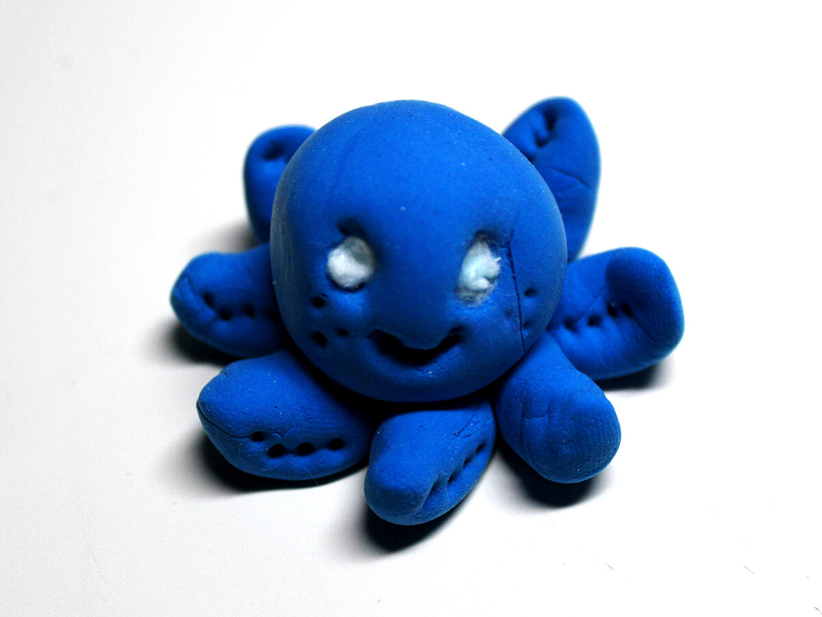 Small blue clay octopus with white eyes (front) 