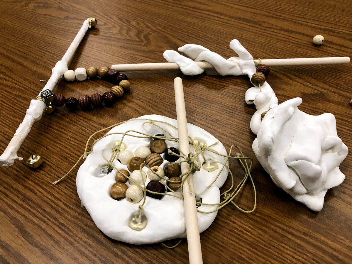 Three hanging sculptures with beads and twine