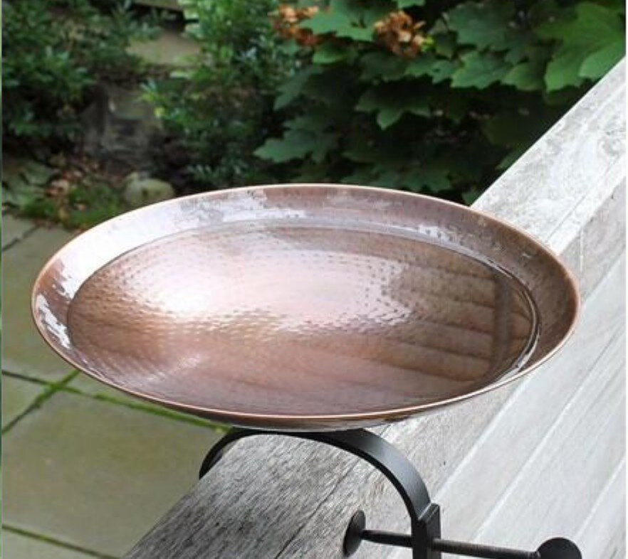 This copper bird bath attaches to the side of a deck making filling and cleaning a simple task.