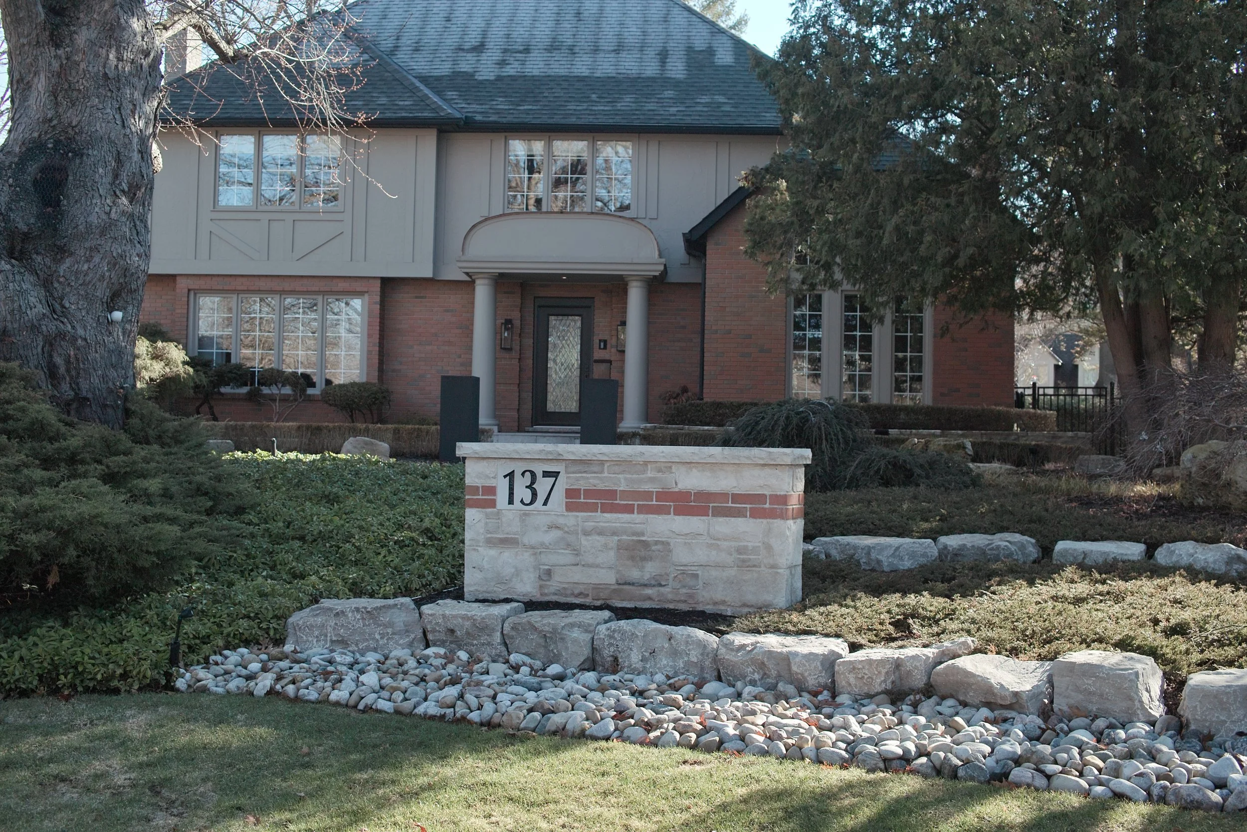 Combination stone and brick knee wall complete with address numbers.