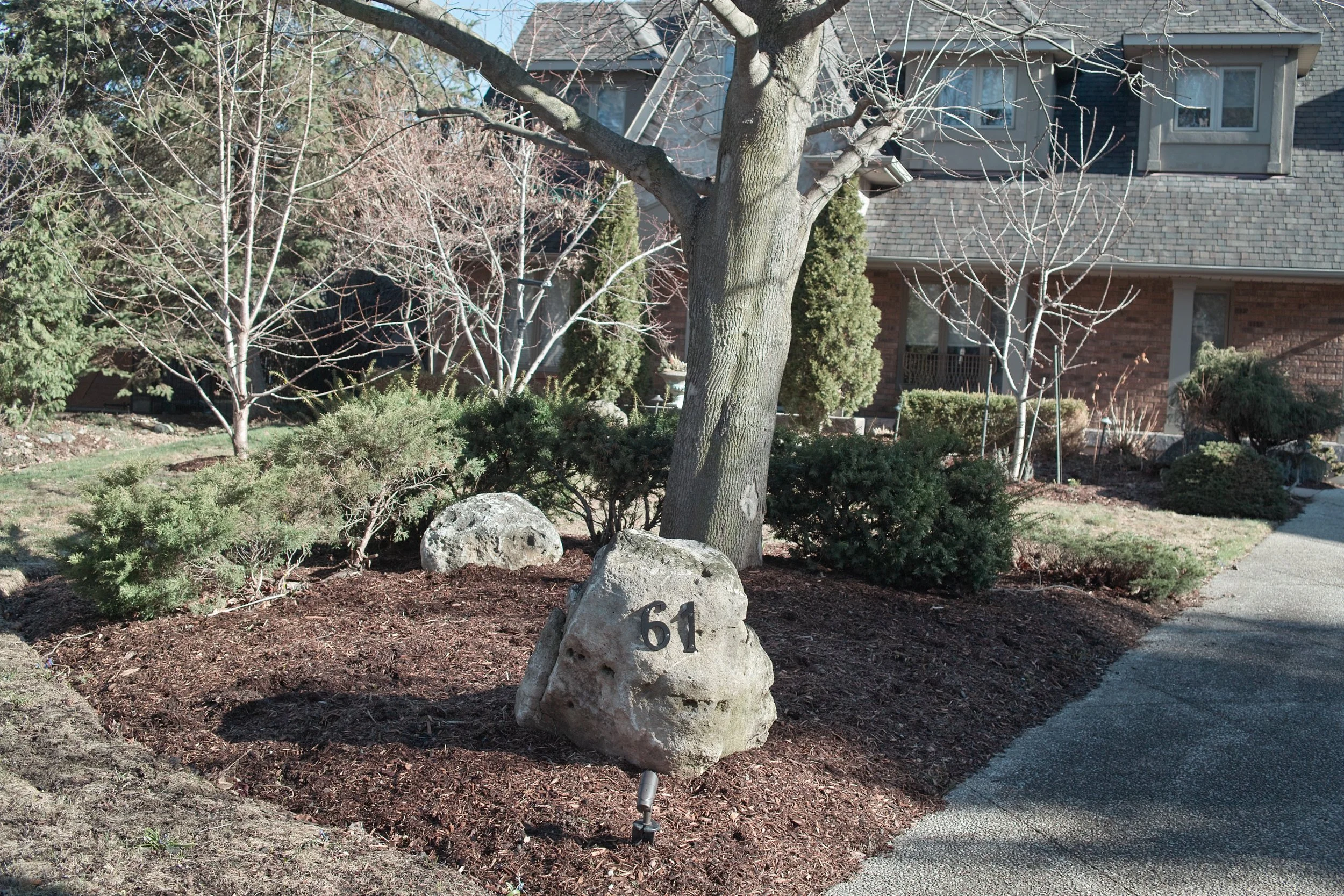 A simple rock with address numbers gives the same effect as a traditional knee wall.