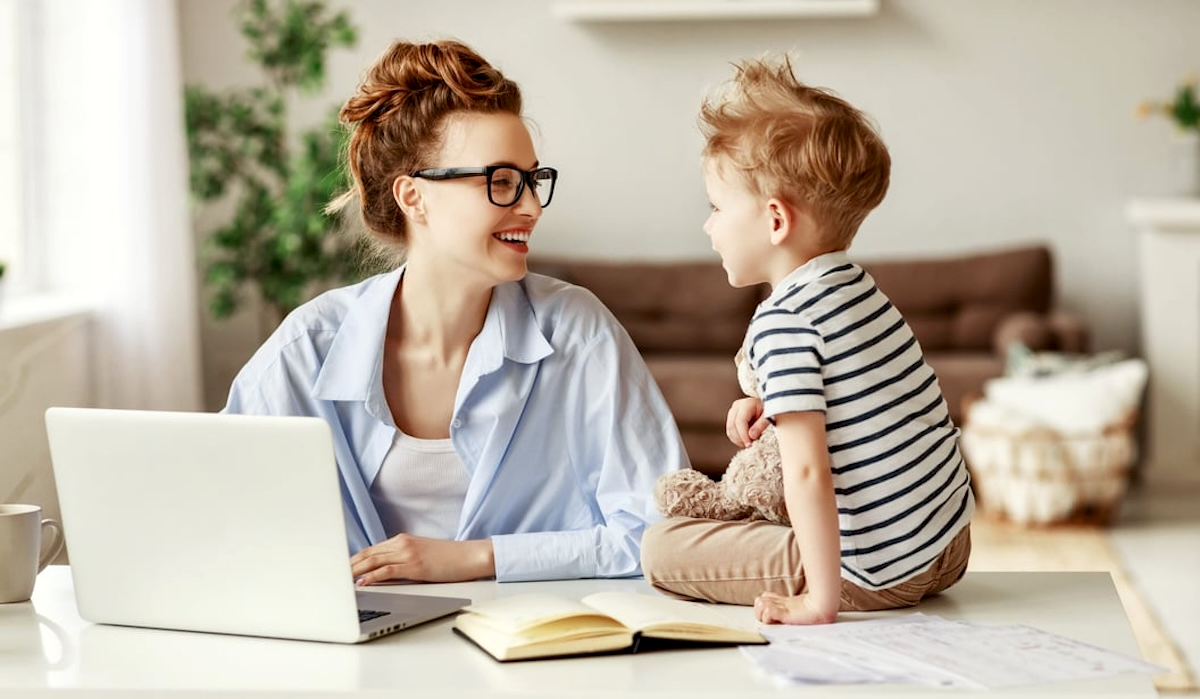 Mama with laptop and child sitting on table