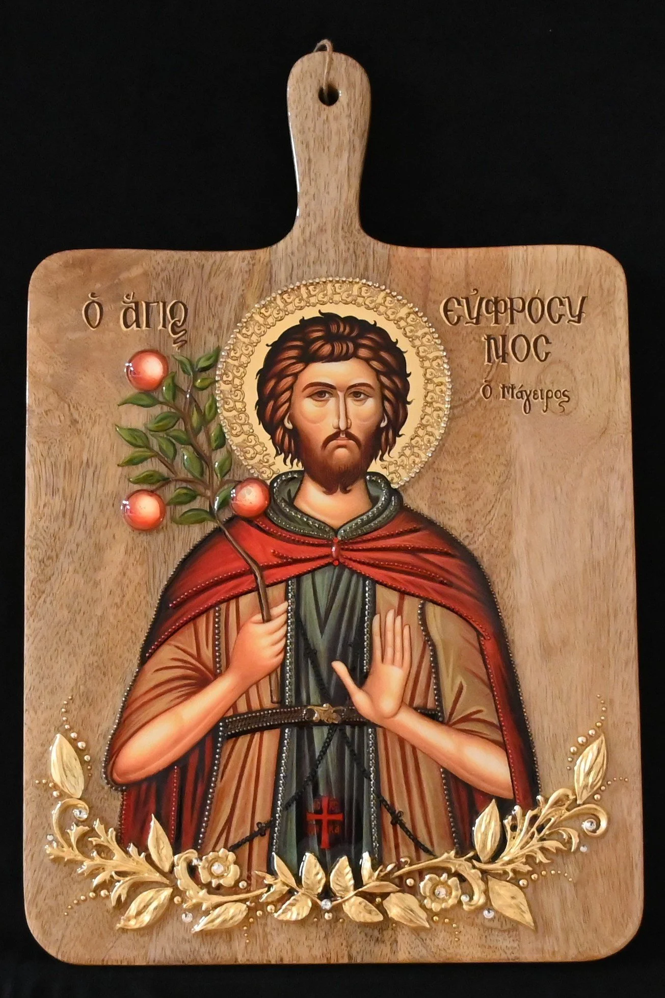 #WD24 SAINT EUPHROSYNOS THE COOK OF ALEXANDRIA  $235
DESCRIPTION: The icon is mounted on a mango wood culinary board (11”x17”). The Saint’s monastic garments are defined with colored metal strands. The base of the icon is bordered with multidimension