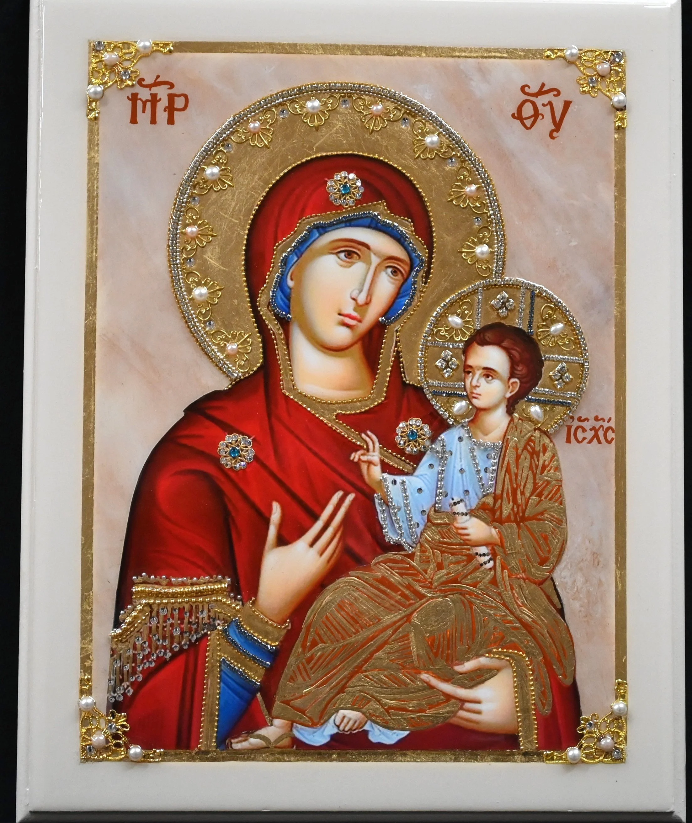 SOLD  #WD18 PANAGIA ODIGITRIA   $265

DESCRIPTION: This icon is mounted on a wood board (11” x 14”). The marbled background has hues of light rose and peach. Christ and Panagia’s photostephana (halos) are gold-gilded and adorned with filigree pieces,