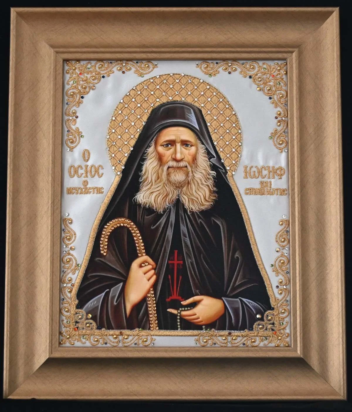 #EMB3 SAINT JOSEPH THE HESYCHAST  $150
DESCRIPTION: Embroidered icon (7 ½”x 9 ½”) is matted to a gold wooden frame (11” 13”) on an ivory satin background.  The border of the icon is adorned with gold metallic thread, crystals and gold balls. The phot