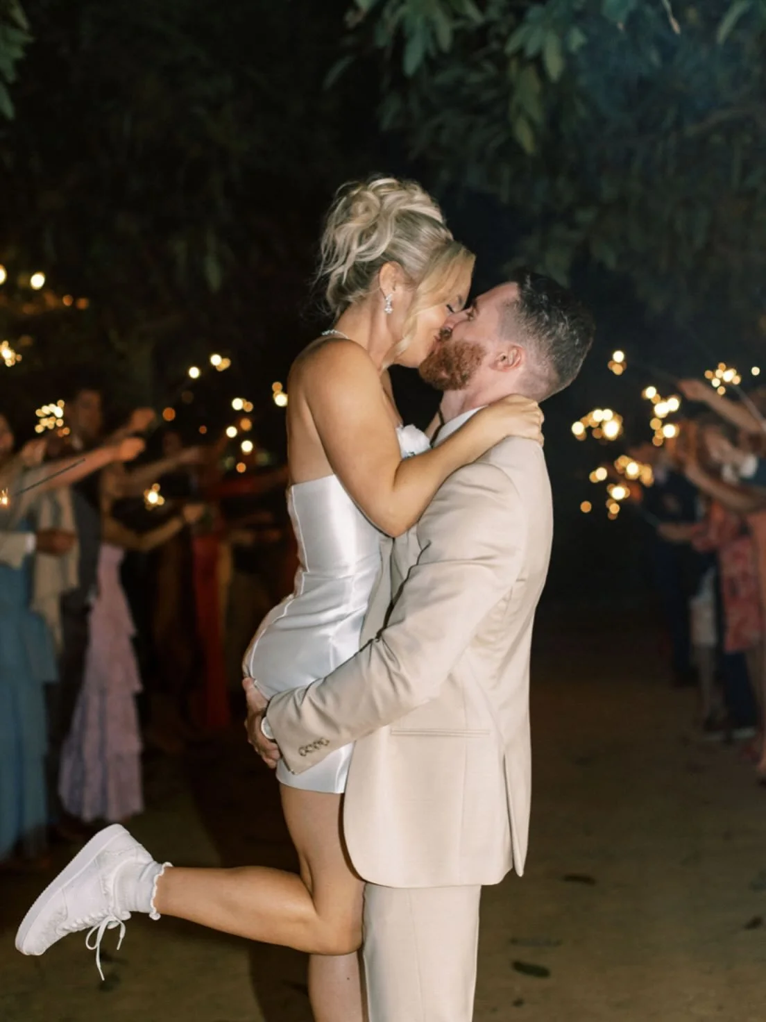 Ending the night in the sweetest way. Our beautiful bride being swept off her feet by her husband, and her hair and makeup is still picture-perfect. We loved creating this timeless look that stayed flawless from &ldquo;I do&rdquo; to the very last da