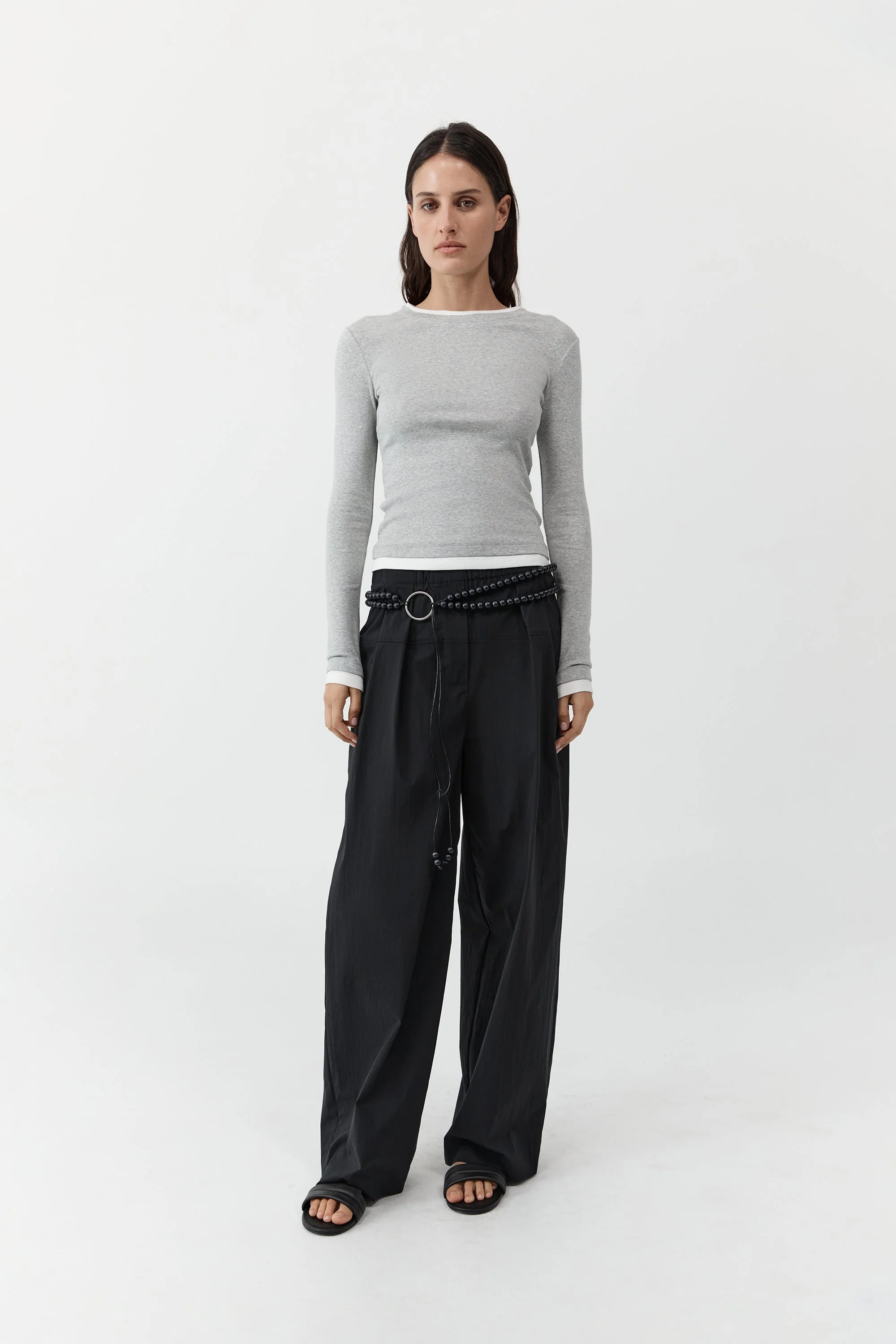 ST AGNI | BLACK RELAXED PLEAT PANTS.