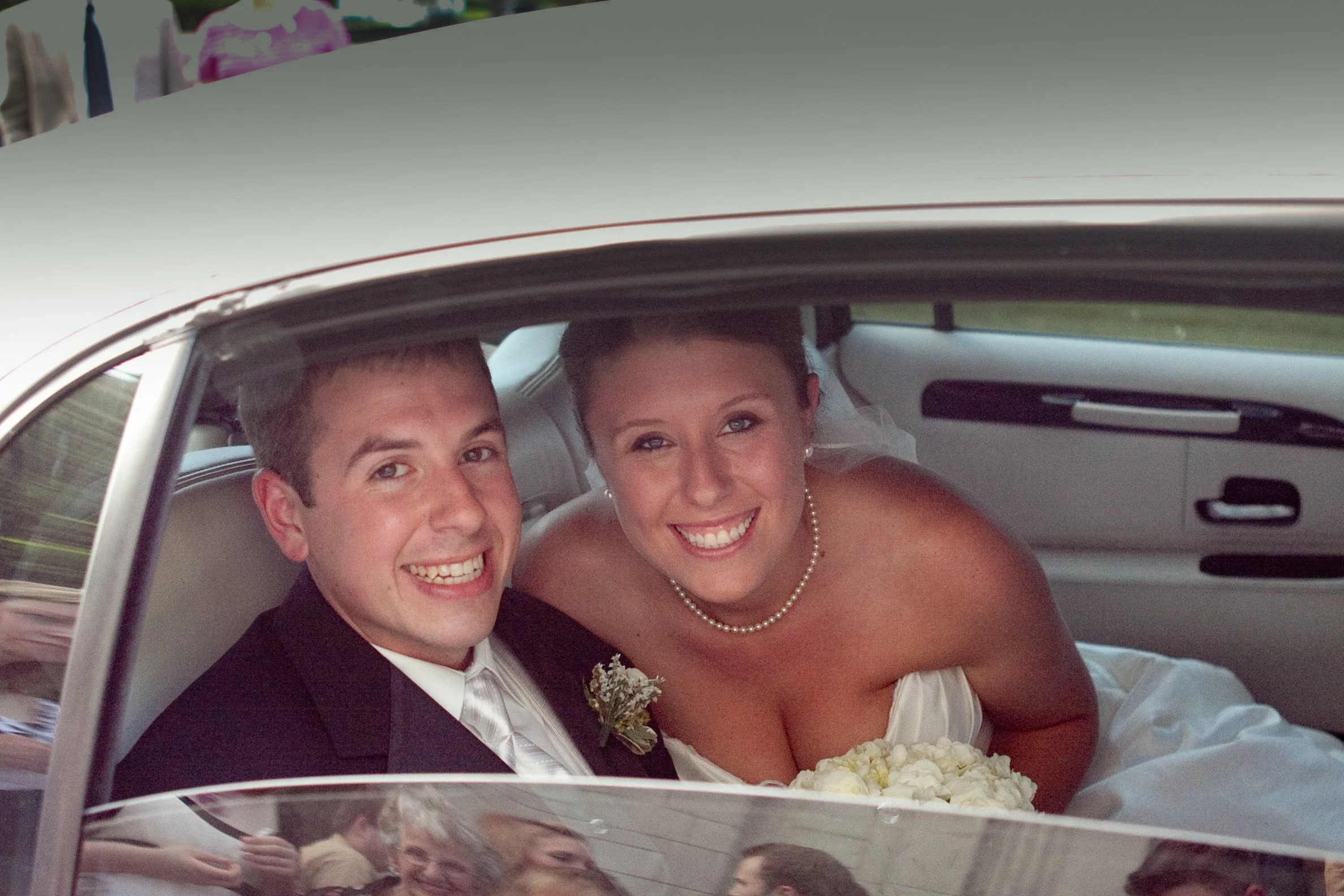 Bride and groom in limo smiling.JPG