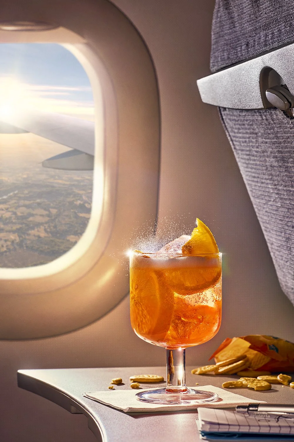 FoodPhotographerLondon_CharlotteNott-Macaire_AperolSpritzOnPlane_TuscanFieldsOutTheWindow.jpg
