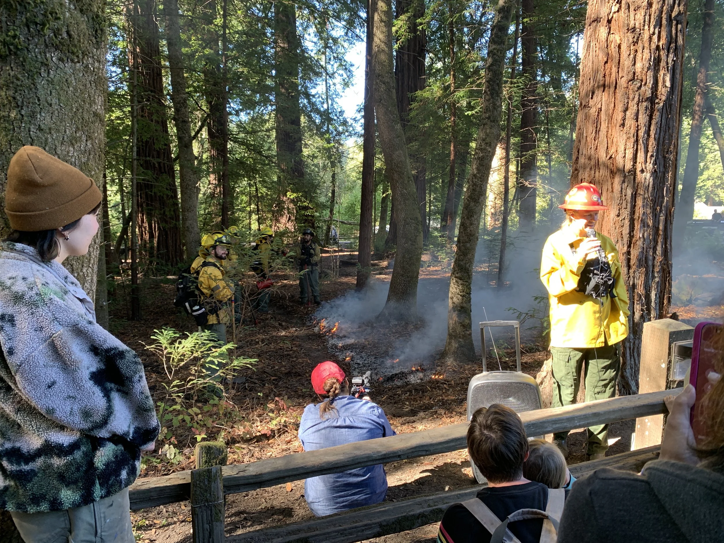 Photo of a burn boss discussing the burn with community members