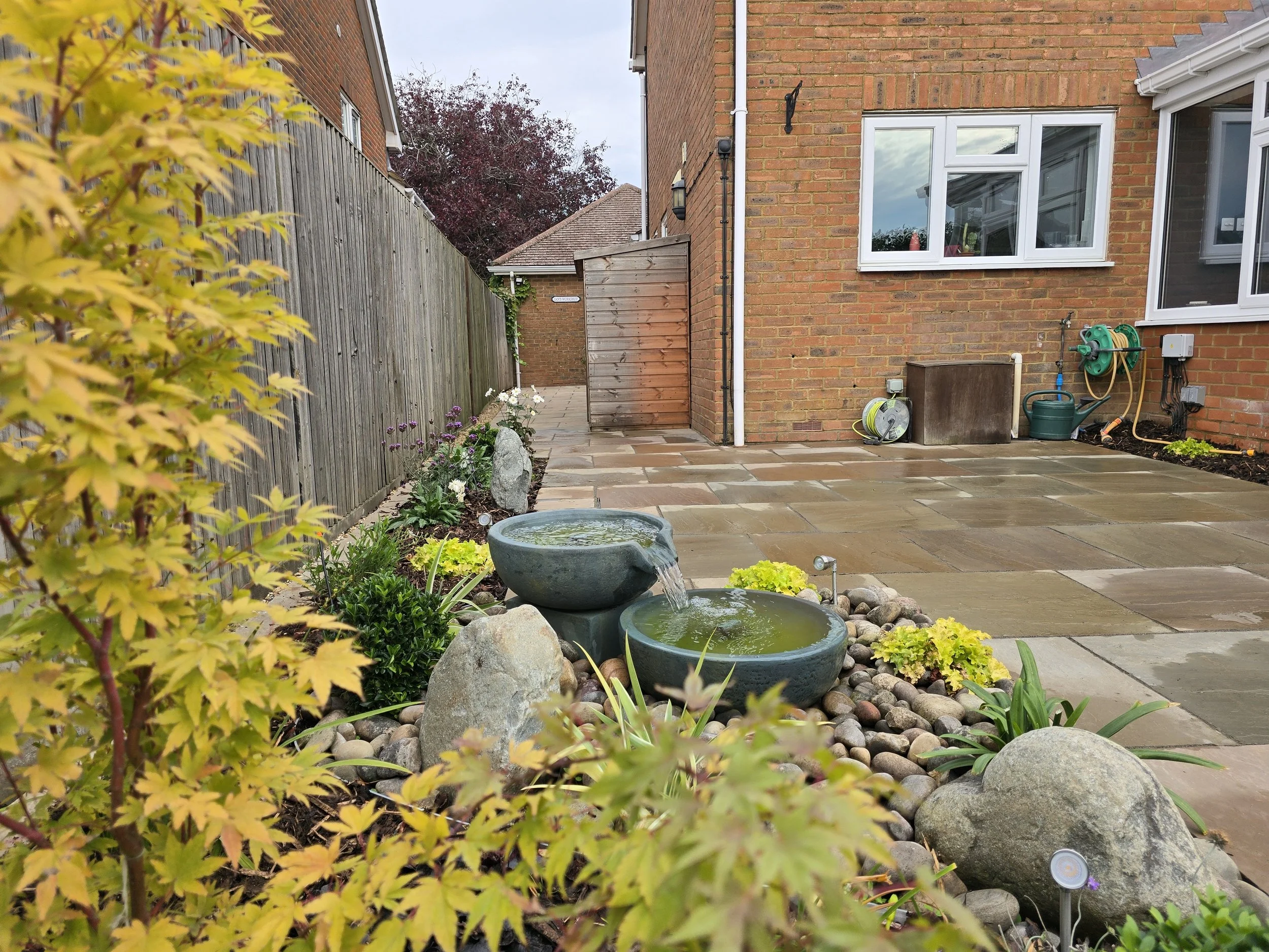 An Acers, Boulders, Cobbles and Plants provide space for the Aquascape Spillway Bowl and Basin.