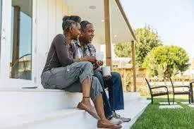 Middle aged couple contemplating on front porch steps illustrating how retirement is changing