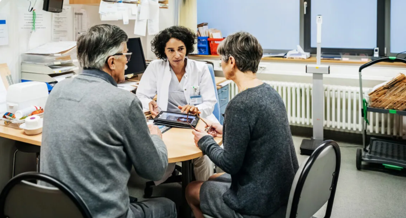 Senior couple sitting down with doctor showcasing how Seniors Can Counter Ageism From Medical Professionals.