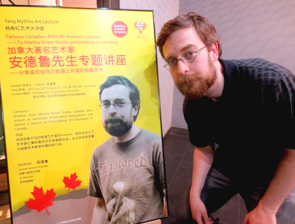 webAndrew with poster in China.jpg