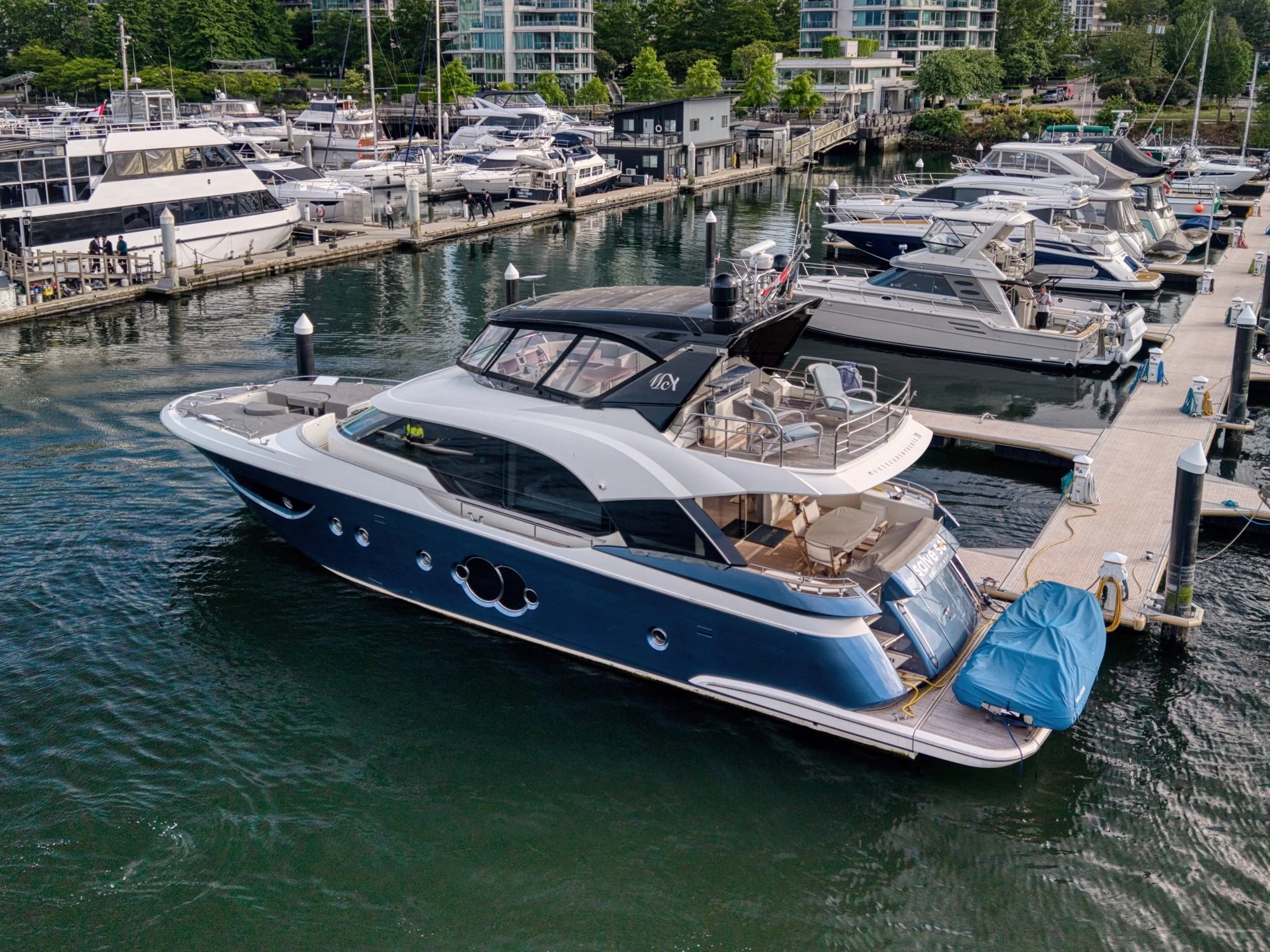 Luxury motor yacht moored at a Vancouver marina, aerial view by Scenic Sky Visuals
