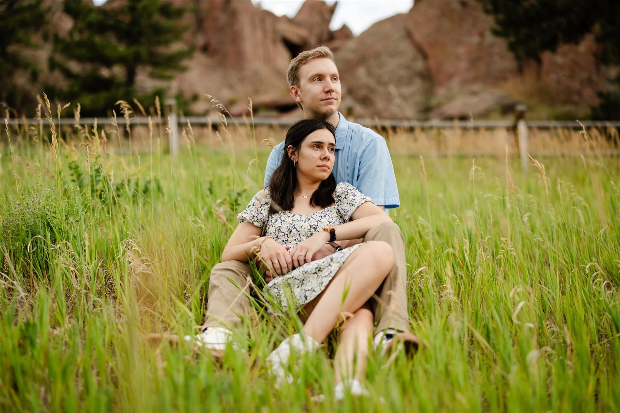 couple sitting together in tall grass