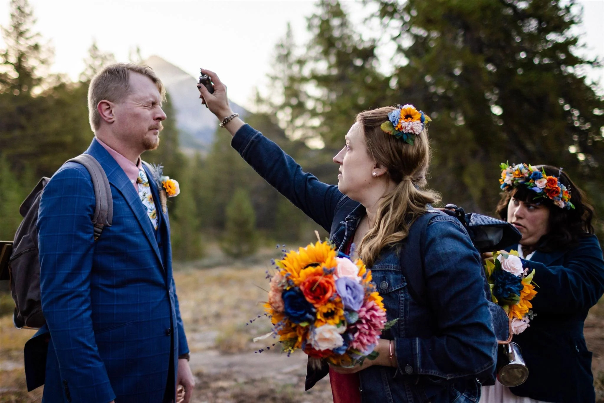 maid of honor fixes grooms hair with hairspray during crested butte elopement