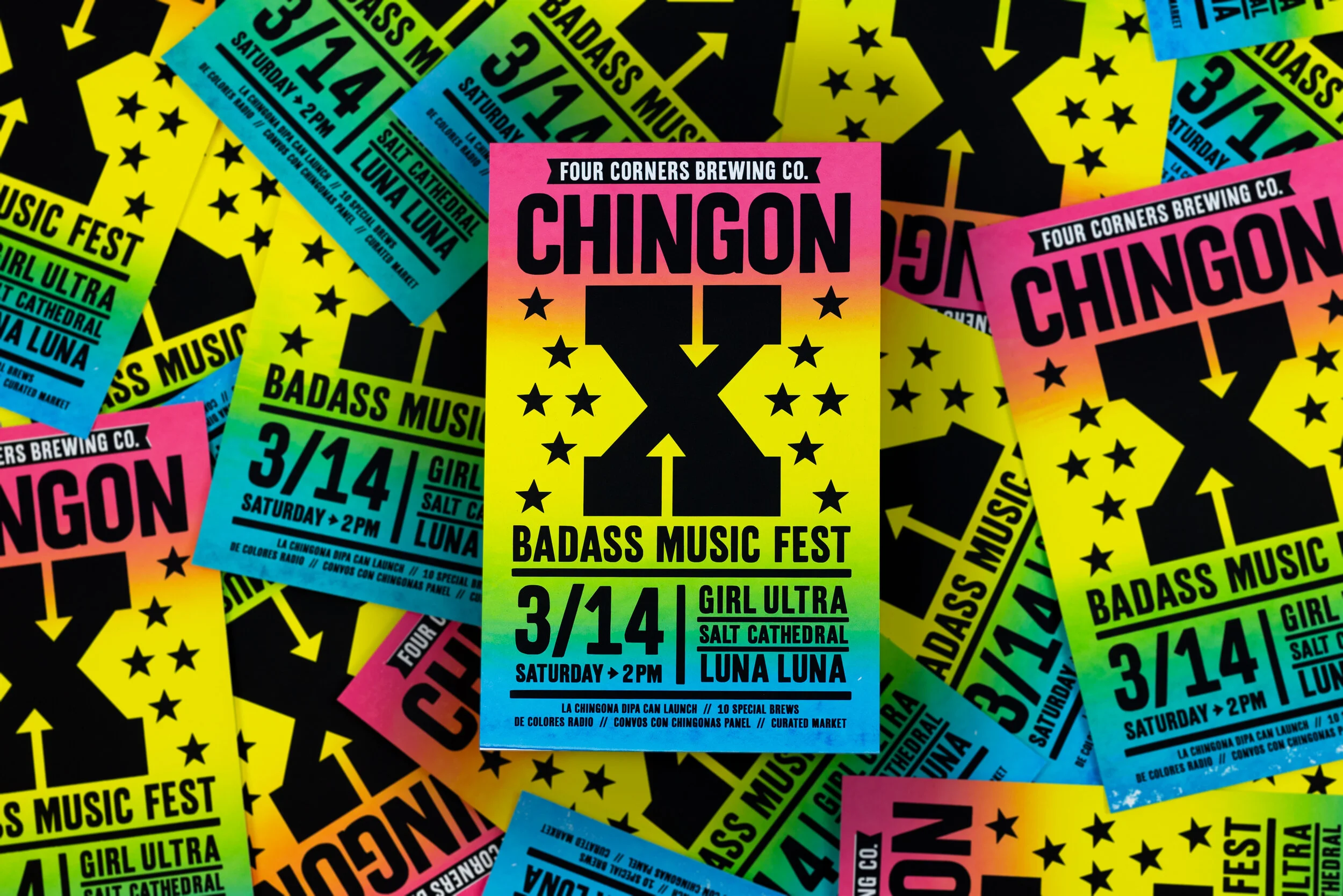 Multiple overlapping posters with vibrant colors advertising a music festival called Badass Music Fest, featuring acts Girl Ultra and Luna Luna on Saturday, March 14 at 2 PM. The posters have a black background with yellow stars and arrows, with brig